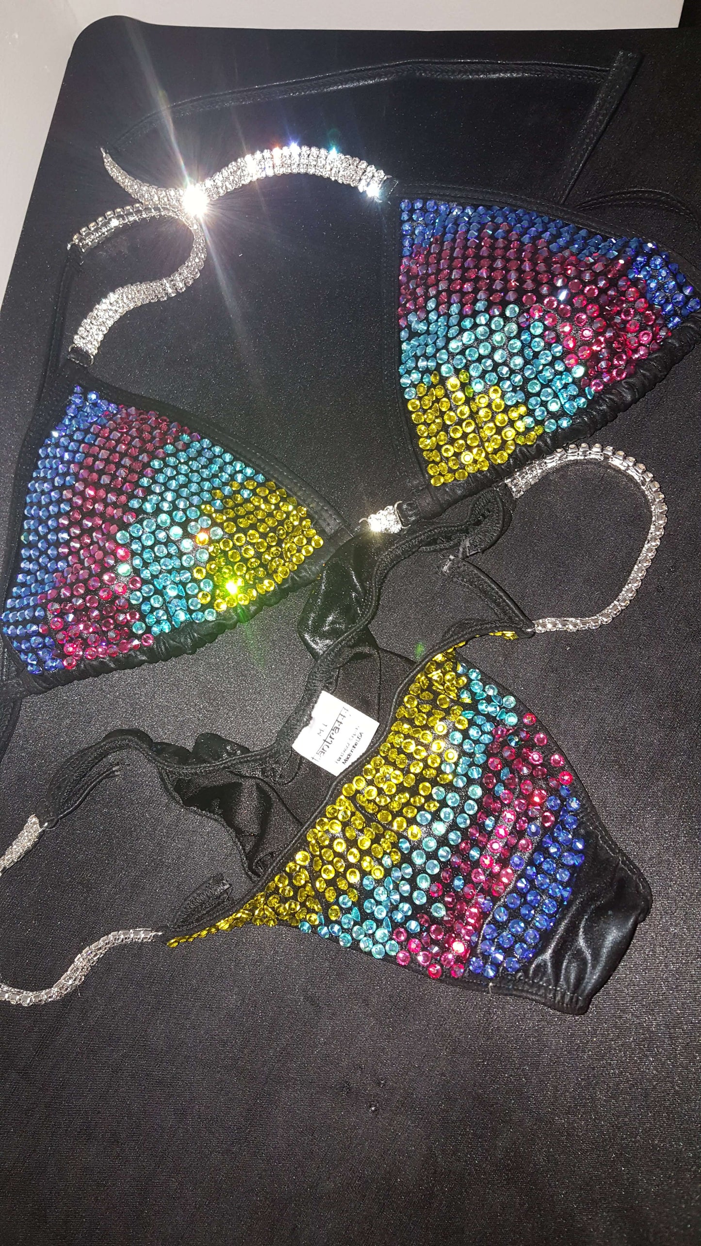Black bikini with rainbow colored rhinestones design.